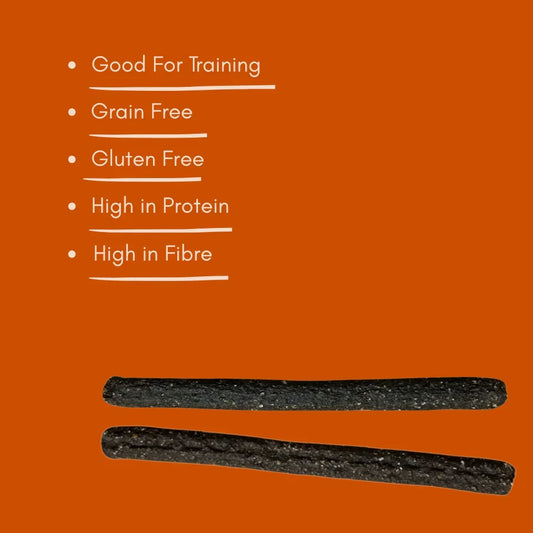 Two natural chicken meaty sticks for dogs, high protein, grain free, displayed on orange background.