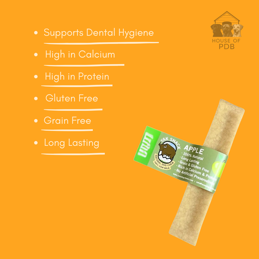 Large Apple yak dog chew with label on an orange background, featuring text about product benefits.