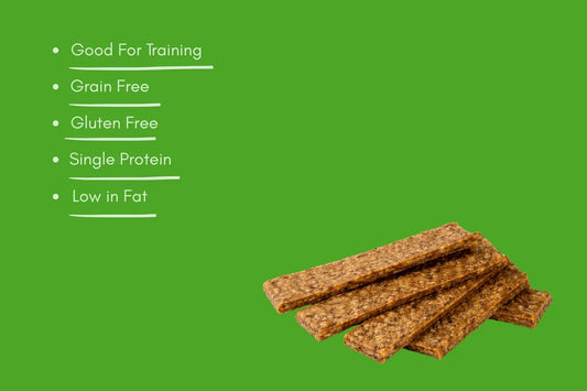 Natural rabbit strips dog treats, grain free, gluten free, on green background with benefits listed.