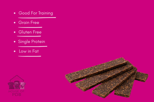 Dog treat bars on a pink background with text highlighting benefits