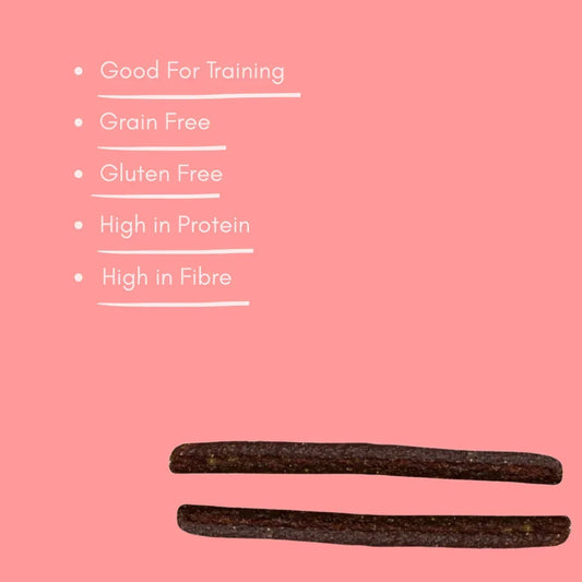 Ham and cheese meaty dog treats, grain free and high protein, on pink background with benefits list.
