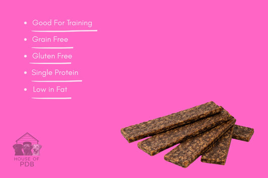 Dog treat bars on a pink background with text highlighting benefits