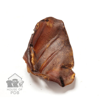 Single dried pig ear dog chew on white background with House of PDB logo