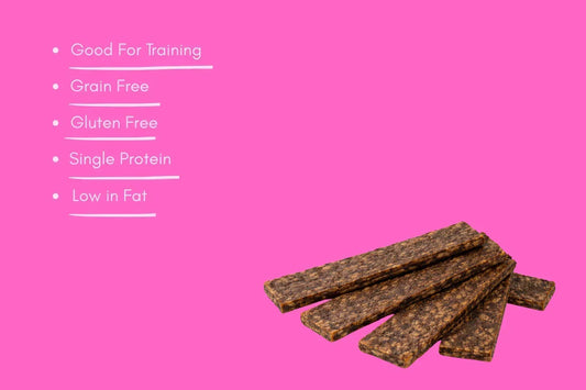 Lamb strips natural dog treats on pink background with training, grain free, gluten free benefits listed.