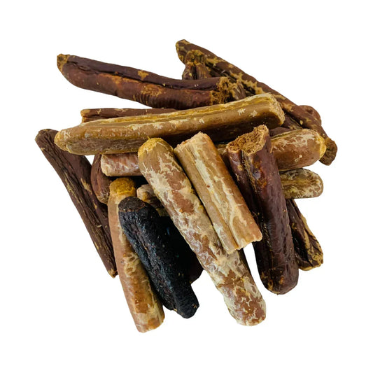 Pile of mixed natural broken sausages, dog treats from House Of PDB on white background